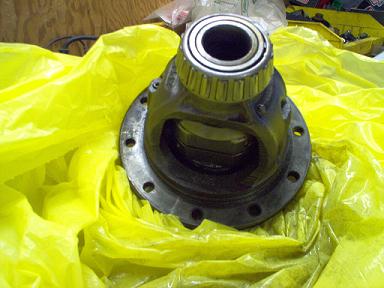 1988 Ford Bronco - Differential carrier assembly with roller bearings, resting on yellow plastic.