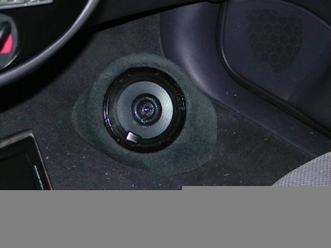 1999 Ford Taurus - A close-up view of a car's interior speaker, highlighting its placement on the floor.