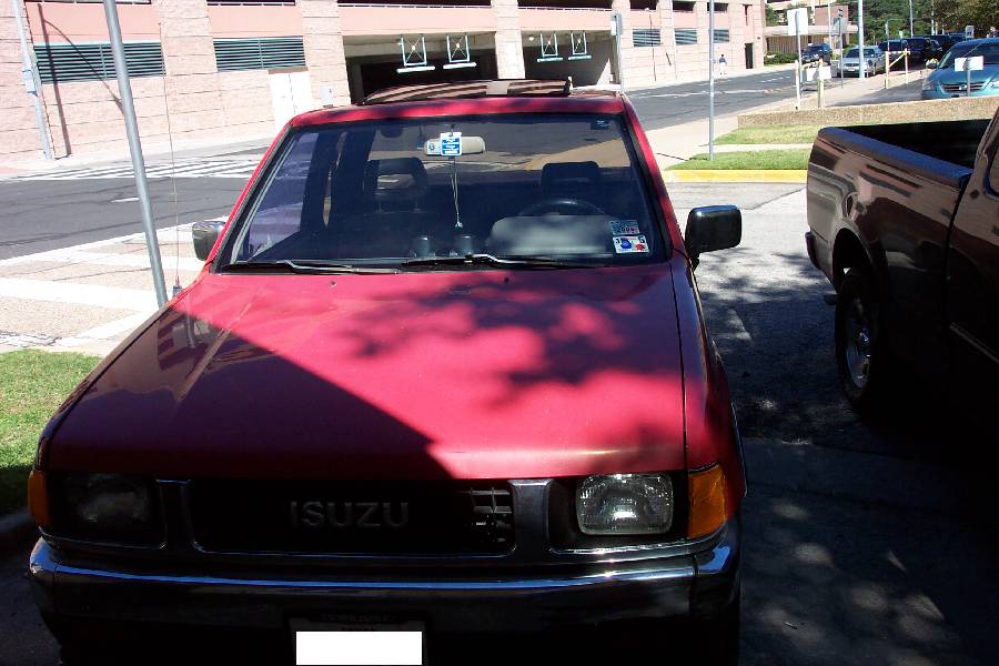 Red Isuzu pickup truck front view