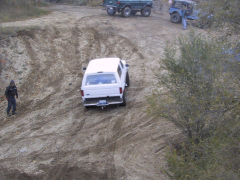 1993 Ford Bronco - Three off-road vehicles navigate a steep dirt incline during an outing.