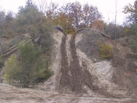 1993 Ford Bronco - A muddy track ascends a challenging hill, suggesting off-road activity.