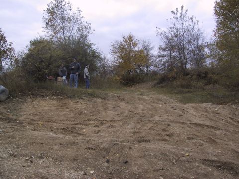 1993 Ford Bronco - Group of people gathered on a dirt embankment with trees and overcast sky.