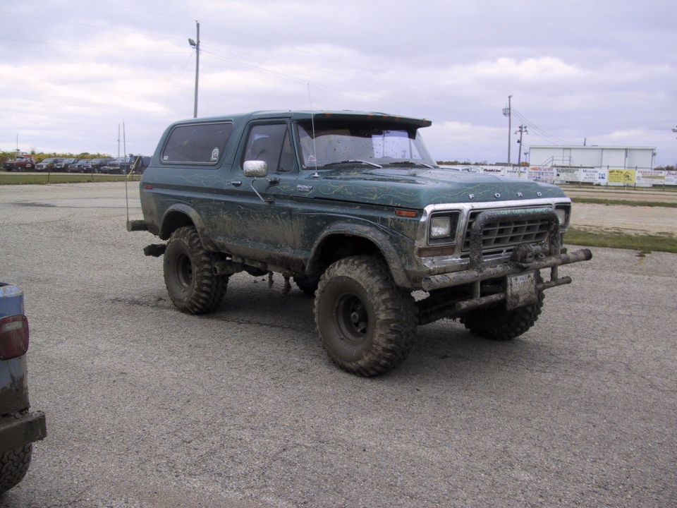 Green lifted Ford Bronco with aftermarket grille guard