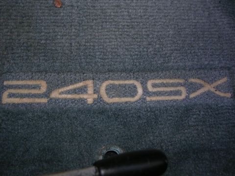 1995 Nissan 240SX - Embroidered '240SX' text is visible on a car's floor mat.