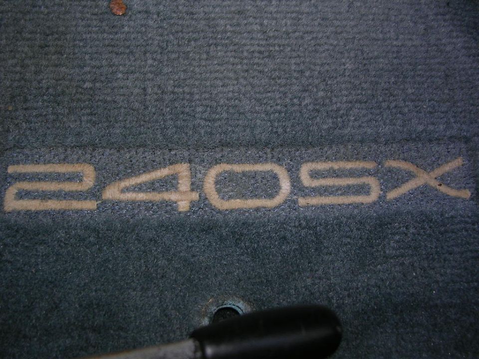 Car floor mat with embroidered '240SX' text