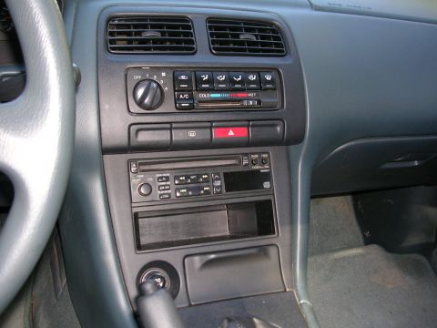 1995 Nissan 240SX - Interior view of a 1995 Nissan 240SX dashboard, showing the center console with audio and climate controls.