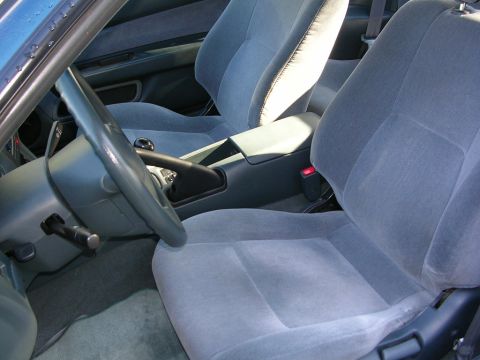 1995 Nissan 240SX - The interior of a car, gray cloth seats and a view of the dashboard and steering wheel.