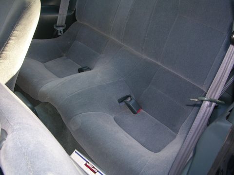 1995 Nissan 240SX - Interior view of gray fabric rear car seats with seat belts and a Kirkland box on the floor.