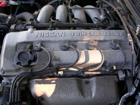 1995 Nissan 240SX - Close-up of a Nissan Twin Cam 16 Valve engine, showing spark plug wires and engine cover details.