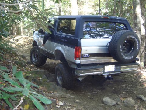 1993 Ford Bronco - This 1993 Ford Bronco navigates a challenging off-road path, its capability on rough terrain.
