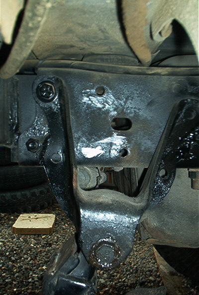 1986 Ford Bronco - This photo shows a close-up of a vehicle's frame and a bolted bracket, not a specific model year.
