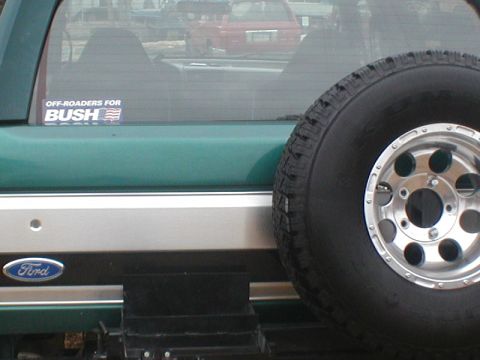 1979 Ford Bronco II - A green 1979 Ford Bronco II is seen from the rear, a spare tire and an "Off-Roaders for Bush" sticker.