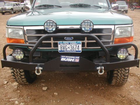 1979 Ford Bronco II - Front view of a green Ford truck equipped with an aftermarket bumper and PIAA driving lights.