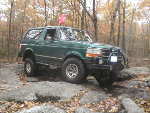 1979 Ford Bronco II - This Ford Bronco is navigating a rocky trail surrounded by autumn foliage.