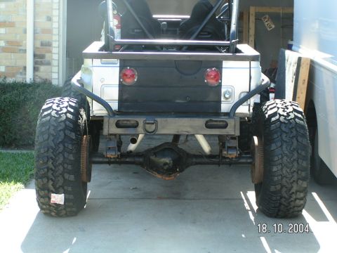 1978 Ford Bronco - Rear view of a heavily modified Jeep CJ with large tires and a custom bumper.