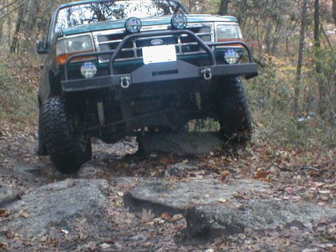 1979 Ford Bronco II - Ford F-Series truck tackles rocky terrain on an off-road trail.