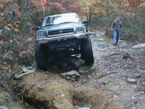 1979 Ford Bronco II - A Toyota 4Runner tackles a challenging off-road course during autumn.