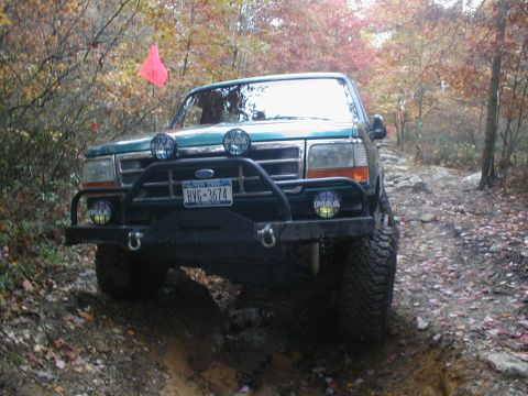 1979 Ford Bronco II - Green Ford Bronco navigates a challenging rocky path during an off-road excursion.