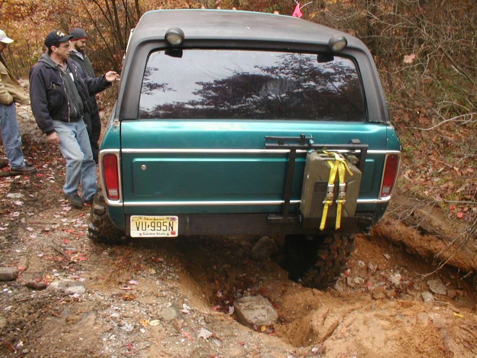 Green 1979 Ford Bronco II rear view with spare gas can mounted