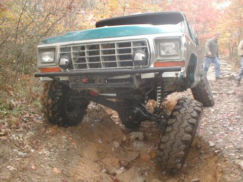 1979 Ford Bronco II - Modified 1979 Ford Bronco II navigating a challenging off-road obstacle.
