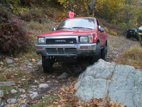 1979 Ford Bronco II - A red Toyota 4Runner navigates a rocky trail during autumn.