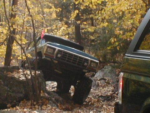 1979 Ford Bronco II - Off-road vehicle tackling rocky terrain during autumn.