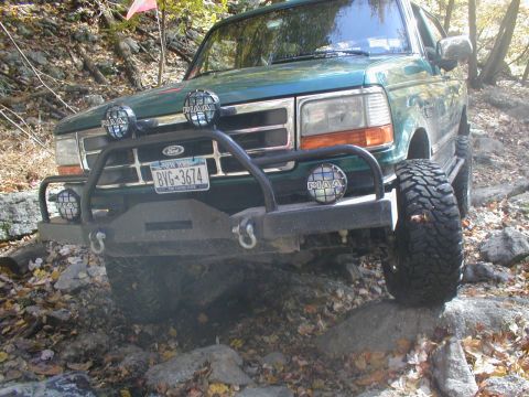 1979 Ford Bronco II - This green Ford Bronco navigates a challenging rocky trail.