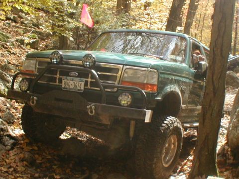 1979 Ford Bronco II - Ford Bronco navigating a challenging off-road course with a pink flag visible.