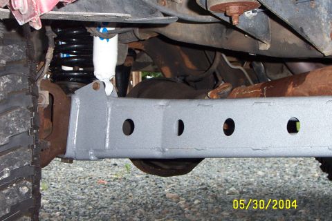 1996 Ford Bronco - Undercarriage view of a 1996 Ford Bronco, highlighting its lifted suspension and off-road tire.