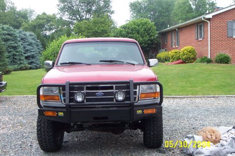1996 Ford Bronco - Front view of a red 1996 Ford Bronco equipped with a heavy-duty bull bar.