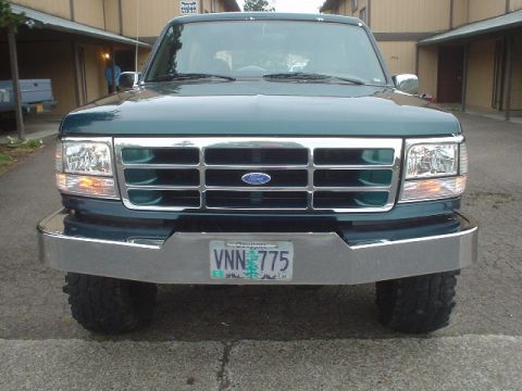 1993 Ford Bronco - This 1993 Ford Bronco is captured from the front, its grille, headlights, and chrome bumper.