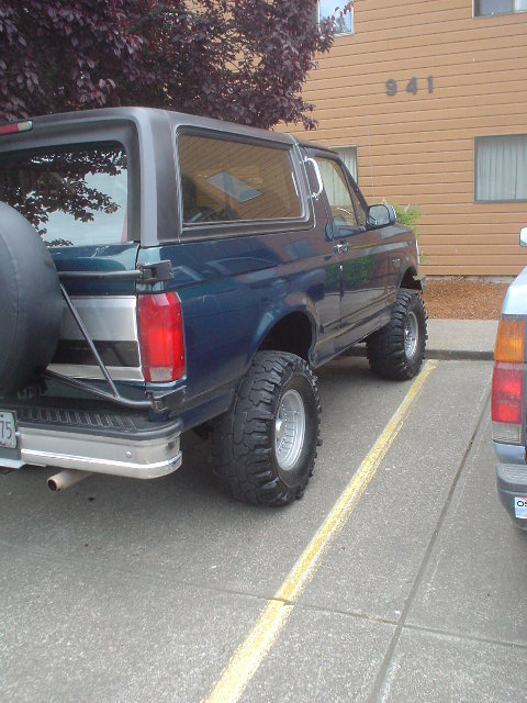 1993 Ford Bronco - Rear view of a lifted 1993 Ford Bronco parked in a lot.