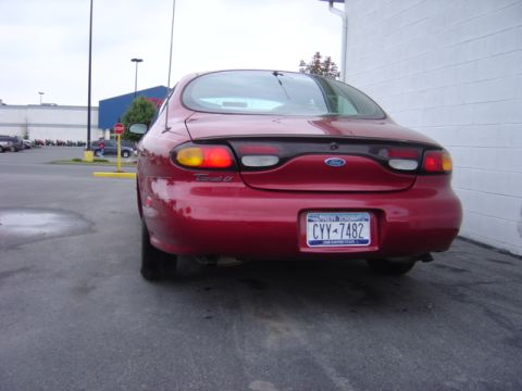 1998 Ford Taurus - 1998 Ford Taurus rear view parked next to a building.