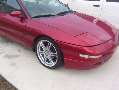1997 Ford Probe - Front 3/4 view of a red 1997 Ford Probe with aftermarket wheels.