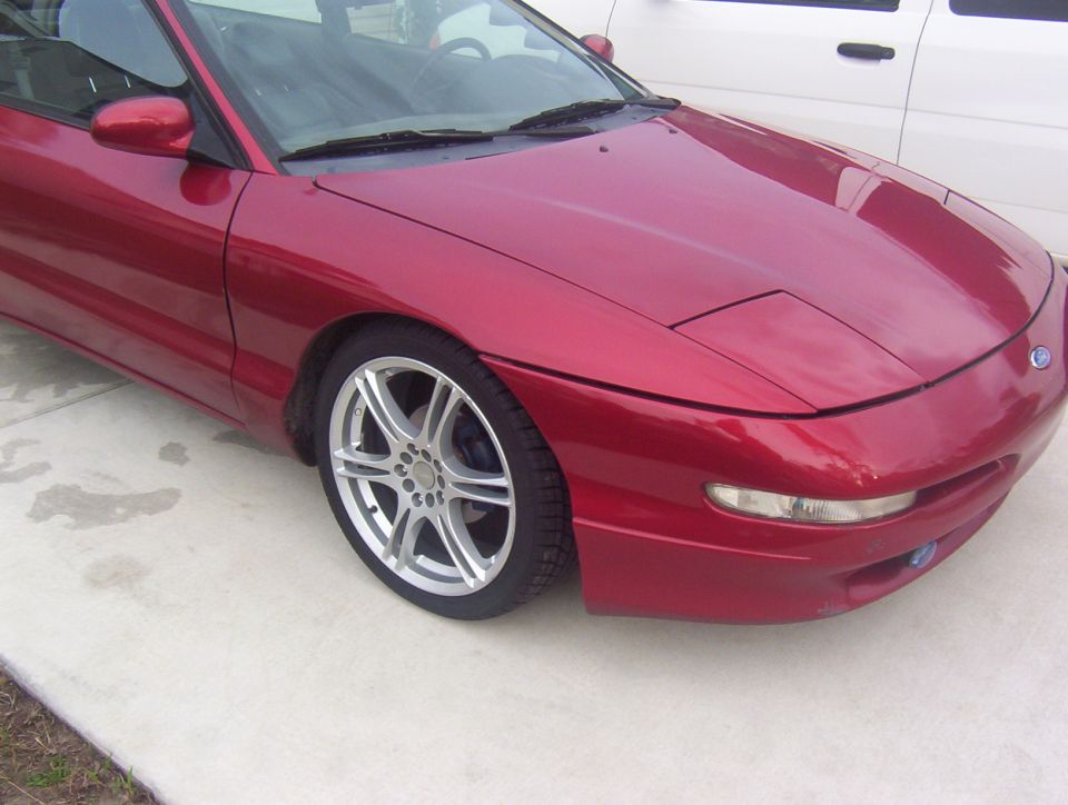 Red 1997 Ford Probe front quarter view, showing the hood, fender, and wheel