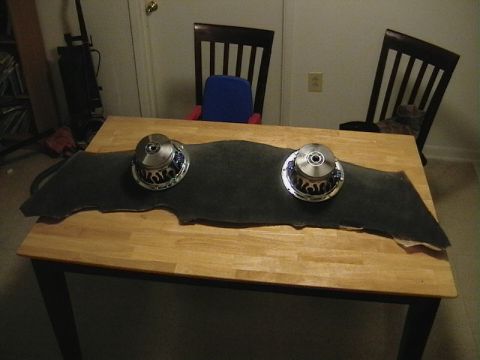 1999 Ford Taurus - Two car subwoofers are placed on a felt pad on a wooden table.