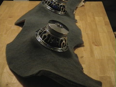 1999 Ford Taurus - Two car subwoofers are mounted on a custom grey fabric panel, likely for installation in a vehicle's audio system.