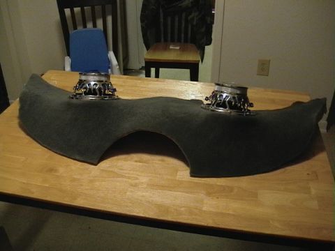 1999 Ford Taurus - Car speaker pods with speakers installed, resting on a wooden table.