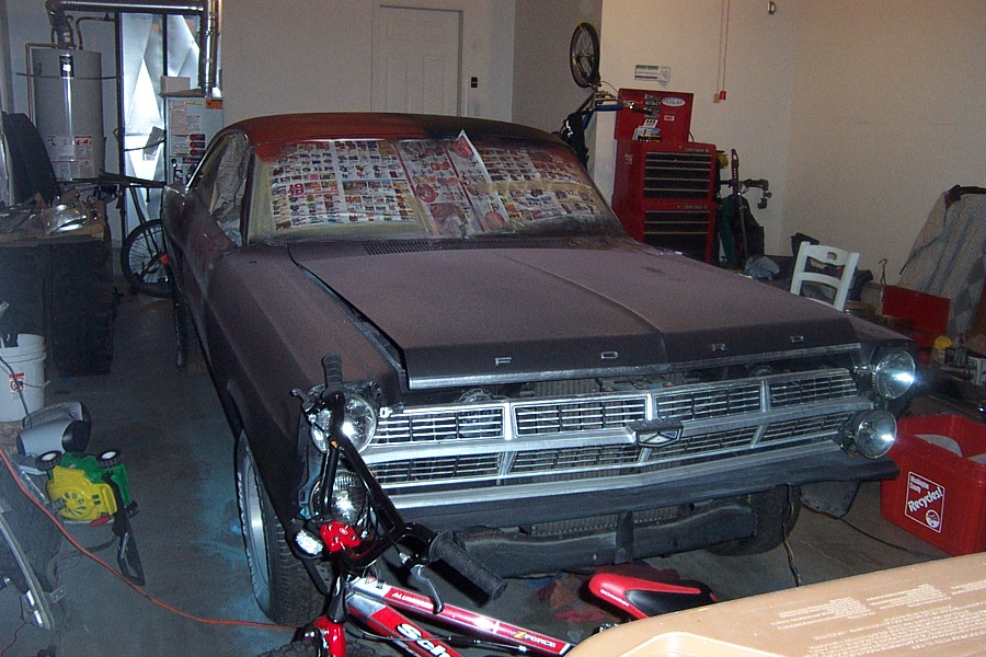 Maroon Ford coupe front 3/4 in garage with newspaper on windshield