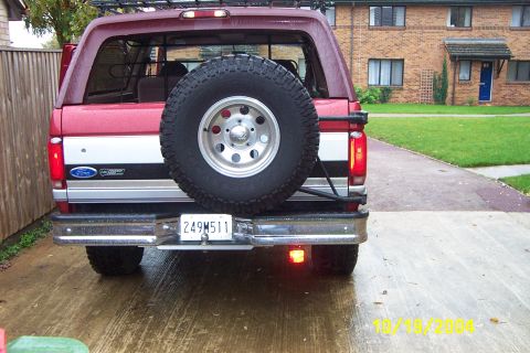 1996 Ford Bronco - Rear view of a 1996 Ford Bronco, its signature spare tire mount and two-tone paint scheme.