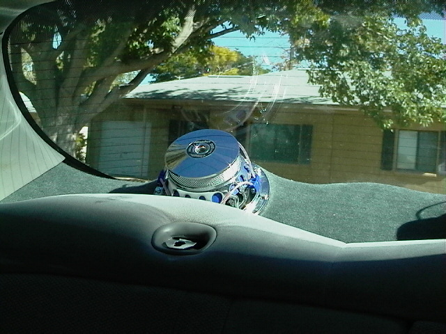 Chrome and blue car stereo speaker on dashboard