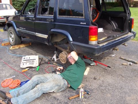 2000 Jeep Cherokee - Tim tapping the new bolt holes