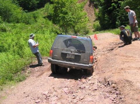 2000 Jeep Cherokee - Jeep Cherokee tackling an off-road trail with onlookers.