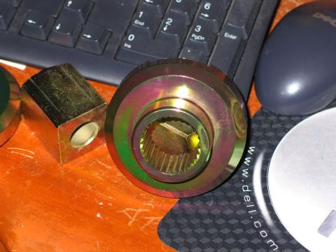1995 Ford Bronco - A differential gear part and a metal block are shown on a desk, with a keyboard and mouse in the background.