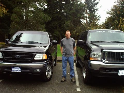 2004 Ford Excursion - Man poses with his Ford F-150 and Ford Excursion parked side-by-side.