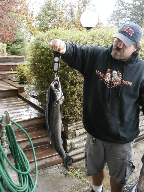 1993 Ford Bronco - A man proudly displays a large fish he has caught, weighing it on a digital scale.