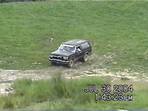 1988 Ford Bronco - 1988 Ford Bronco navigating a muddy off-road course.