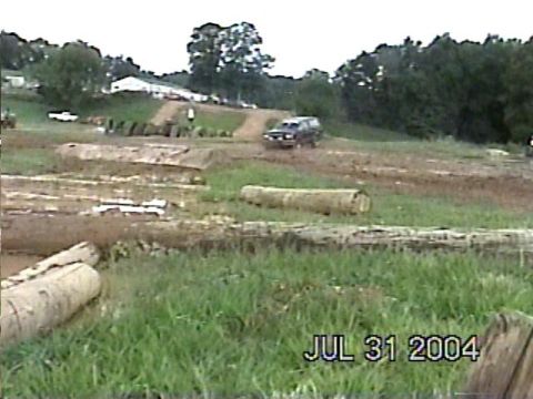 1988 Ford Bronco - A vehicle navigates an off-road course with various obstacles and terrain features.