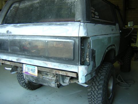 1984 Ford Bronco - This 1984 Ford Bronco is in the process of restoration, showing its rear quarter panel with a primer finish and a visible license plate.