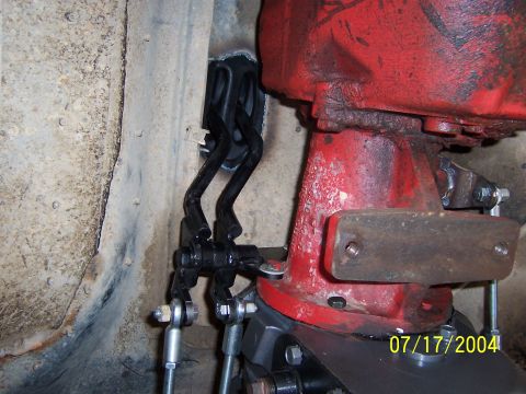 1978 Ford Bronco - Close-up view of the transfer case linkage mechanism, a red housing and a visible date watermark.